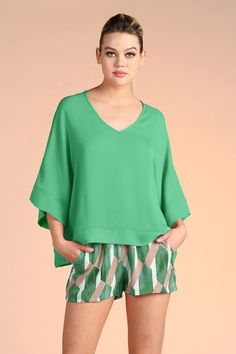 A chic flowy top, ready to take you from the office to a night out on the town. Our beautiful Crinkle Fabric is soft to the touch and has similar movement to chiffon. The kimono-style adds effortless style, while the band hemline adds edge. V neckline Kimono sleeves Band hemline Crinkle texture Chiffon-like fabric 100% Polyester Made in USA Brielle is 5'9.5" and is wearing a size small. SKU #: T-4430 Crinkle Top, Crinkle Fabric, Strapless Romper, Kimono Sleeves, Strapless Jumpsuit, Flowy Top, Strapless Tops, Jumpsuit With Sleeves, Kimono Sleeve