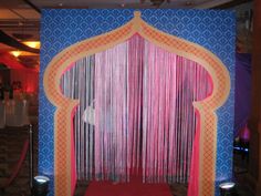 the stage is decorated with pink and blue drapes