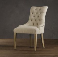 a white chair sitting on top of a wooden floor