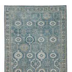 a blue and beige rug with an intricate design