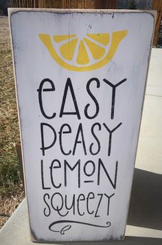 a sign that says easy peasy lemon squeezer on the side of a road