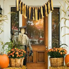 an outdoor halloween porch decorated with pumpkins and scarecrows for decoration, including hay bales