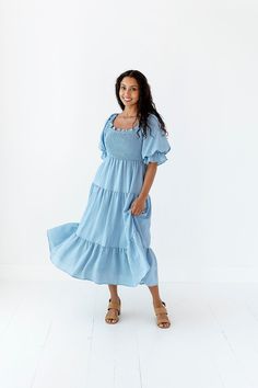 Features Square neck Elbow length elastic sleeve Smocked bodice Pockets Lined 97% Polyester, 3% Spandex Size + Fit Small 0-4, Medium 4-8, Large 8-12 Kristin is 5'4" a size 3 and is wearing a size Small True to size. Size Bust Length Small 41" Medium 41" Large 41" Flowy Smocked Dress With Square Neck And Smocked Bodice, Flowy Smocked Dress With Bodice And Square Neck, Fitted Smocked Dress With Puff Sleeves And Elastic Neckline, Smocked Bodice Dress With Square Neck For Daywear, Square Neck Smocked Dress For Daywear, Billowy Smocked Dress With Smocked Back For Daywear, Smocked Bodice Short Sleeve Dress, Short Sleeve Smocked Bodice Dress In Solid Color, Fitted Smocked Dress With Square Neck And Elastic Neckline