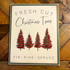 a sign on the wall that says fresh cut christmas trees, fir - pine - spruce