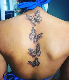 the back of a woman's body with butterflies on her upper and lower back