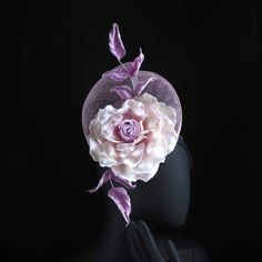 Meet my new Floral Overspill hat in delicate lilac trimmed with an oversized satin rose. This season inspired sinamay beret with a handdyed satin rose is a perfect number for a day at the races, wedding or a summer garden party. The calmness of the pale lilac sinamay, the soft lines of the extended brim and the artfully crafted hand dyed silk rose have all come together in this truly original piece fit for that special occasion of yours. The sinamay hat has been hand blocked and finished with a Purple Handmade Flowers Headpiece For Kentucky Derby, Handmade Pinched Crown Hat For Wedding, Purple Headpiece With Handmade Flowers For Kentucky Derby, Elegant Purple Flower Fascinator, Handmade Hat For Royal Ascot Wedding, Handmade Hats For Wedding At Royal Ascot, Lavender Fascinator For Wedding At Royal Ascot, Handmade Wedding Hat For Royal Ascot, Rose Wedding Fascinator With Handmade Flowers