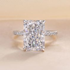 a cushion cut diamond ring with pave set shoulders