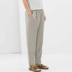 Zara Relaxed Draped Front Trousers In Sand.....Size S. Slinky Soft Weave; 100% Lyocell. Light Grayish Beige/Ivory/Stone. Crossover Draped Pleated Front. Elasticized Waistband At Back. Side Zipper Closure. Slanted Front Pockets. Relaxed Tapered Legs. Waist Across 14.25". Front Rise 10.75". Hip Across 20.75". Inseam 27.5". Leg Opening 6.25" Across. New With Tag. Relaxed Fit Gray Bottoms For Spring, Gray Relaxed Fit Bottoms For Spring, Fitted Gray Pants For Summer, Gray Straight Leg Summer Bottoms, Gray Relaxed Fit Straight Bottoms, Gray Relaxed Fit Straight Pants, Elegant Gray Bottoms For Spring, Spring Gray Bottoms, Zara Tapered Leg Bottoms In Solid Color