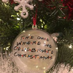 a glass ornament hanging from a christmas tree that says the one where we celebrate christmas