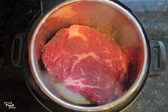 raw meat in an instant pot on the stove