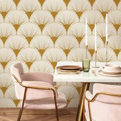 a dining room table with two chairs and plates on it