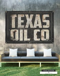 a couch sitting in front of a sign that says texas oil co