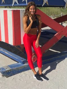 a woman posing in front of an american flag