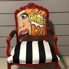 a red chair with a black and white striped pillow on it's back that says omg