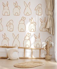 a white room with gold rabbit wallpaper and wooden bench in front of the window