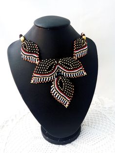 "Original beautiful beaded necklace in black and red gold. Beadwork. The modern design of the necklace will emphasize your individuality and originality, beads will complement any look. This necklace made of delicate leaves suits any outfit. Jewelry for women. An unusual gift for a friend. The size of the necklace is 45 cm (17.71 \"). Three Leaf Pendant Length 9 cm (3.54 \") If you have any questions for me, please contact me. Thanks for watching and interest in my work." Bright Necklace, Beautiful Beaded Necklaces, Modern Jewellery Design, Jewelry Choker, Leaf Jewelry, Leaf Necklace, Leaf Pendant, Unusual Gifts, Gold Beads