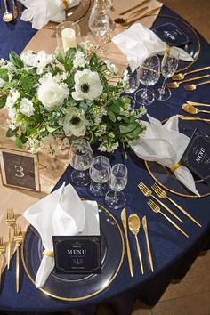 a table set with place settings, napkins and silverware for an elegant dinner