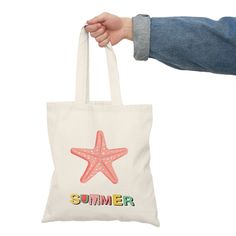 "Dive into the magic of summer with our Starfish Summer Tote Bag, featuring a captivating pink starfish illustration and the word \"summer\" written below in a delightful array of colorful letters. This canvas tote captures the enchantment of the season, allowing you to carry the vibrant hues and carefree spirit of summer wherever you venture. 🌟 Key Features: * Playful Starfish: The charming pink starfish illustration brings the beach to life and adds a touch of whimsy to your style, making you feel like you're seaside all year round. * Colorful Typography: The word \"summer\" is elegantly spelled out in an array of vivid and joyful colors, reflecting the vibrant energy of the season. * Durable Canvas: Crafted from sturdy canvas material, this tote bag is designed to accompany you on your Pink Canvas Bag For Daily Summer Use, Casual Reusable Canvas Bag For Summer, Pink Reusable Beach Bag, Summer Beach Bag As A Gift, Pink Canvas Bag For Summer Vacation, Summer Canvas Gift Bag, Eco-friendly Pink Canvas Beach Bag, Summer Travel Reusable Canvas Bag, Summer Beach Bag With Letter Print