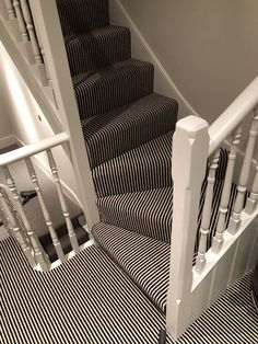 a staircase with black and white striped carpet