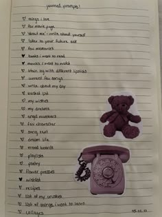 a piece of paper with writing on it and teddy bear sitting on top of the phone