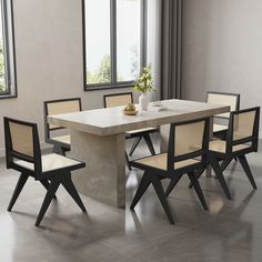 a dining table with four chairs around it