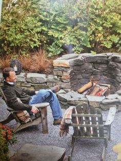 a man sitting in a chair next to a fire pit