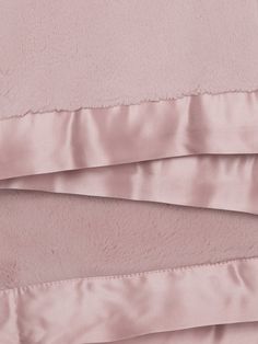 the pink sheets are folded neatly on top of each other