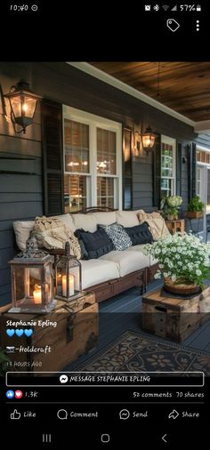 a couch sitting on top of a wooden floor next to a table filled with flowers