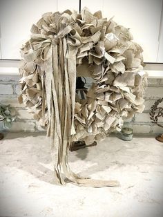 a wreath made out of old newspaper sitting on top of a counter