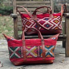 You're going to want to plan a weekend trip just so you can use this beautiful bag! Intertwined's beautifully crafted travel bag is handmade in Morocco from locally tanned leather and vintage, handwoven kilim. Each kilim is one-of-a-kind and handwoven with unique colors and patterns based on the region where it is made. Traditional Rectangular Weekender Bag For Travel, Traditional Woven Leather Shoulder Bag For Travel, Bohemian Leather Rectangular Travel Bag, Bohemian Rectangular Duffle Bag With Leather Handles, Bohemian Leather Travel Bag, Bohemian Brown Satchel Travel Bag, Bohemian Leather Tote Duffle Bag, Bohemian Duffle Bag With Leather Handles For Daily Use, Traditional Tote Weekender Bag For Travel