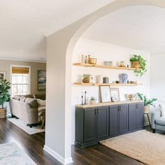 a living room filled with furniture and lots of shelves on top of it's walls