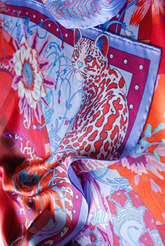 Elevate your wardrobe with this stunning 'Flowers of Time' silk scarf, featuring a vibrant red colour palette and intricate illustration of an ocelot surrounded by a beautiful flowers. The design is inspired by a whimsical flower clock garden from Carl Linnaeus' imagination, where new flowers bloomed with each passing hour. With this scarf, you can carry a piece of that magical garden with you wherever you go. #SilkScarf #Florals #LuxuryFashion #Linnaeus #SamWilde Intricate Illustration, Carl Linnaeus, Whimsical Flower, Stunning Flowers, New Flowers