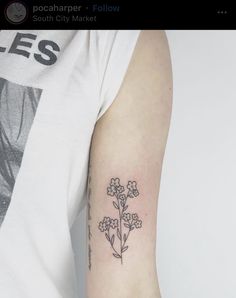 a person with a flower tattoo on their arm