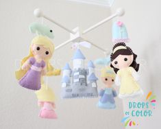 three little princess mobiles hanging from the ceiling