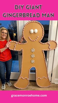 a woman standing next to a giant gingerbread man