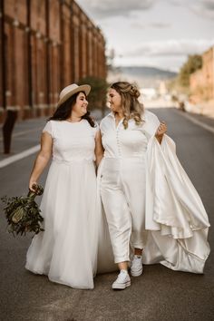 two brides walking down the street together