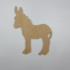 a wooden cutout of a donkey on a white background