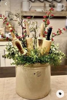 an arrangement of knives and flowers in a pot