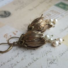 "These stunning antiqued brass tulips make a dramatic statement. Beautifully layered with antiqued bronze caps and accented with lustrous Swarovski pearls in cream, they will add a timeless and elegant piece of jewelry to your collection. Length: 1 3/4\"(45mm) from the bottom loop of leverback, french wire or clip. Prefer a different style of earwire? French wires and non pierced clips are available at no extra charge. Please make a selection from drop down. All Debra Dane jewelry arrives in a p Tulip Earrings, Bijoux Art Nouveau, Antique Earrings, Swarovski Pearls, Dream Jewelry, Earrings Vintage, Bridesmaid Earrings, Buying Jewelry, Cute Jewelry