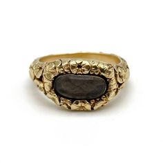 An early nineteenth century gold mourning ring featuring a heavily carved floral pattern throughout and centering an oval compartment with a plait of braided brown hair, engraved to the reverse: W. H. Crowder ob. 3 Mar. 1816 aet 21 (W. H. Crowder died 3 Mar 1816 age 21), size 6 and not sizable, 6.0 grams.  During the early nineteenth century it was common for women to adorn themselves with multiple rings of every shape and style, from amatory rings to mourning rings. As such, a rich diversity of Victorian Oval Engraved Ring, Victorian Engraved Oval Ring, Antique Carved Signet Ring For Ceremonial Use, Luxury Carved Yellow Gold Signet Ring, Oval Ceremonial Carved Jewelry, Victorian Yellow Gold Carved Rings, Victorian Carved Yellow Gold Rings, Vintage Oval Carved Engraved Ring, Heirloom Oval Dome Ring With Rose Cut Diamonds