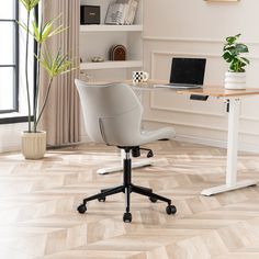 an office chair sits in front of a desk with a laptop on it and a potted plant