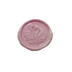 a wax stamp with two swans on it