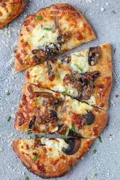 three slices of pizza with cheese and mushrooms on them sitting on a gray counter top