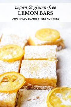 lemon bars with powdered sugar and sliced up lemons on the top are shown