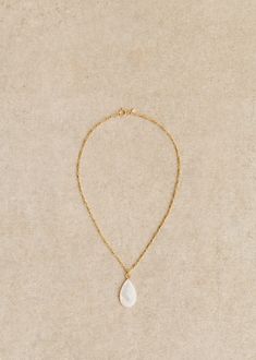 Gold-plated recycled brass and natural mother-of-pearl necklace;The natural material of this jewellery makes it unique: there may be variations in size and colour from one piece to another.;Length: 50 cm / 18.7 in Dainty Mother Of Pearl Pendant Necklace, Brass Pendant Necklace With Pearl Charm, White Drop Pendant Necklace With Delicate Chain, White Pendant Drop Necklace With Delicate Chain, White Delicate Chain Drop Necklace, White Delicate Drop Chain Necklace, Brass Necklace With Pearl Pendant, Mother Of Pearl Pendant Pearl Necklace, Delicate Mother Of Pearl Necklace With Pearl Charm