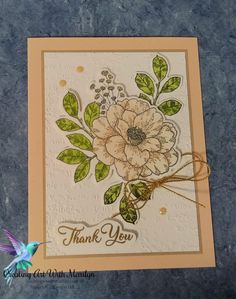 a handmade thank card with flowers and leaves on the front, which reads thank you