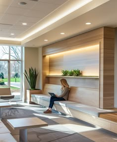 a woman is sitting on a bench in the lobby