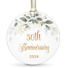 the 50th anniversary ornament is hanging from a gold - plated chain on a white background