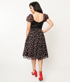 Be careful or you might just get shot in the heart by Cupid's arrow! This adorable 1950s style swing dress is crafted in a black satin-like fabric with a skirt that dances with red outlined white hearts throughout. But the main attraction is the charming rick rack trimmed heart applique on the sweetheart bodice. Complete with a back zipper and elastic short puff sleeves.Crinoline added for volume, sold separately.Available in sizes XS-5X while supplies last. Elastic Shorts, Cupids Arrow, Get Shot, White Heart, 1950s Fashion, Xl Dress, Black Satin, Swing Dress, Unique Vintage