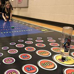 two girls are playing with numbers on the floor